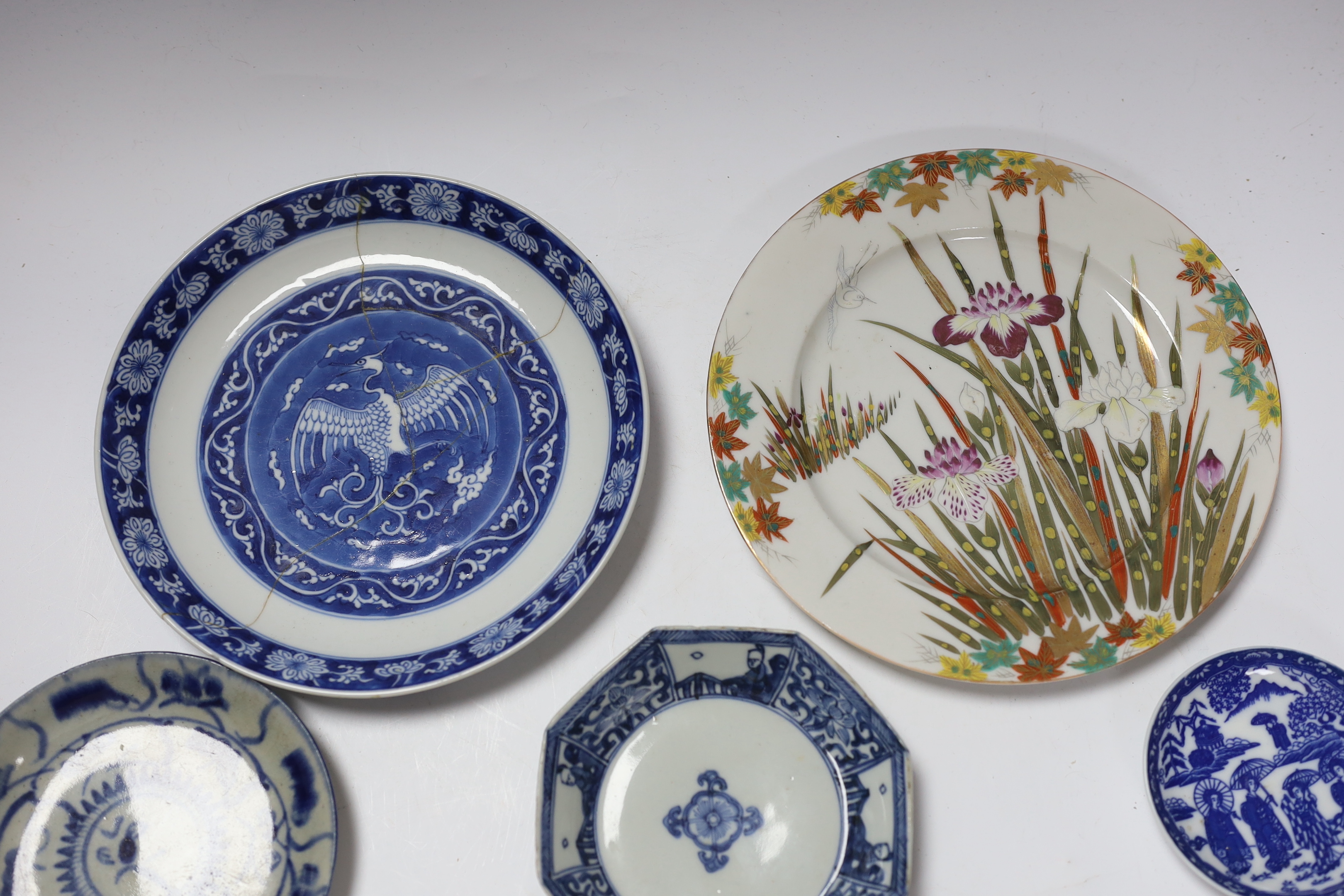 A group of 18th century Chinese porcelain plates and saucers, mostly blue and white and an octagonal famille rose example, together with three Japanese dishes, largest 27cm in diameter